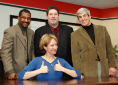 photo shows senior applicants smiling with a lady giving a thumbs up as they have followed the careers advice in this article and been successful in their job hunting as a result